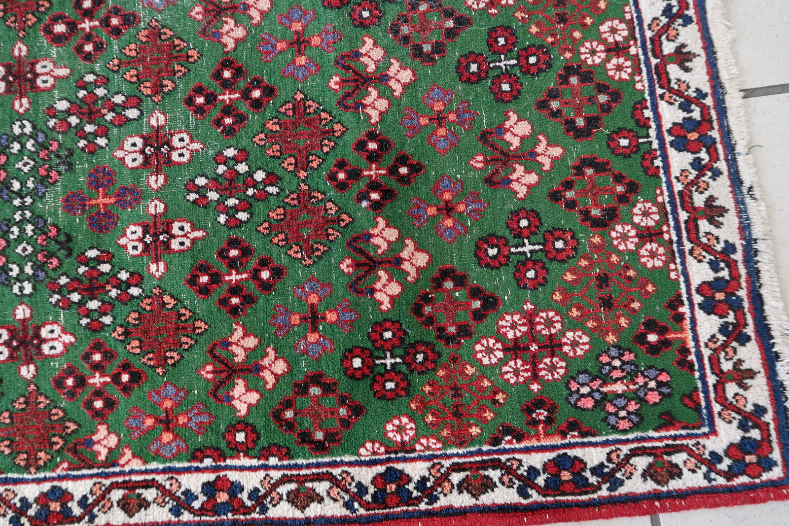Handmade antique Persian Joshagan runner in green color. The runner is from the beginning of 20th century in original condition, it has some low pile.