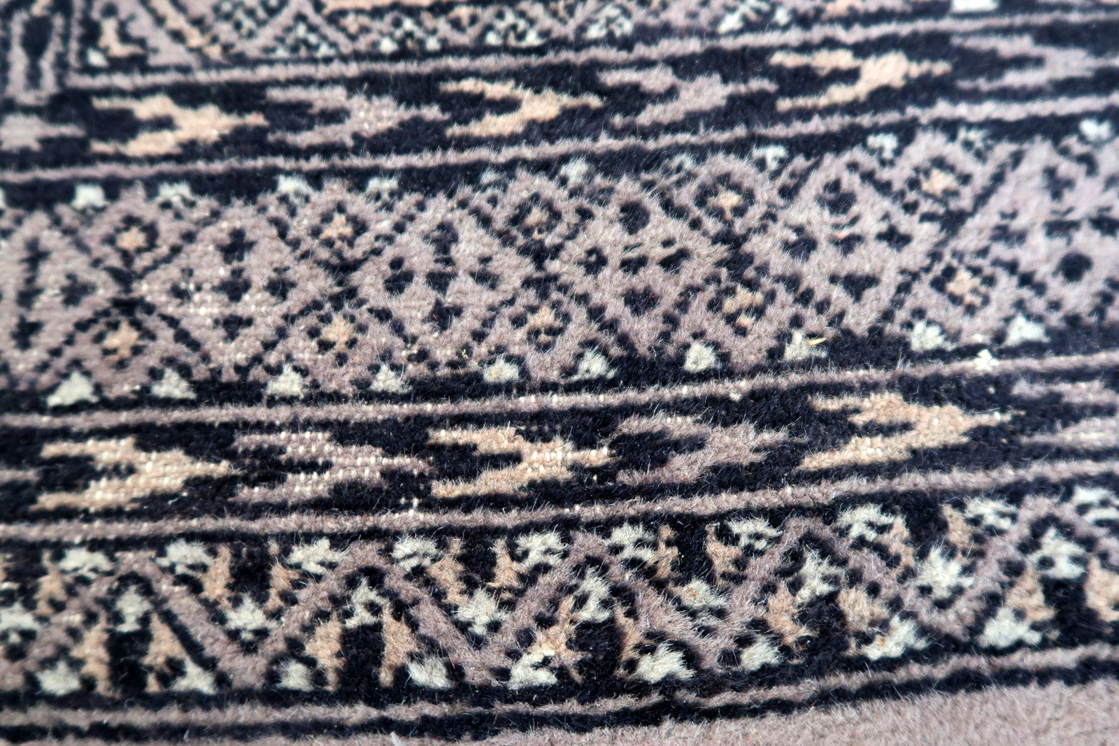 Handmade vintage Uzbek Bukhara rug in traditional design and red color. The rug is from the end of 20th century in original condition, it has some low pile.