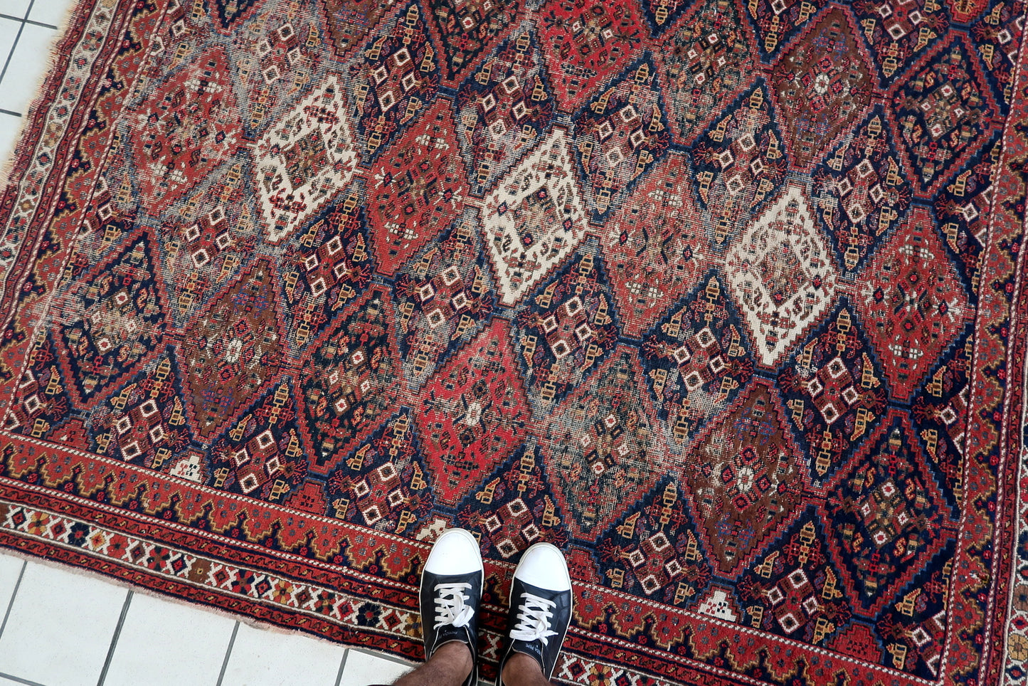 Handmade antique Persian rug from Afshar region. The rug is from the beginning of 20th century in distressed condition.
