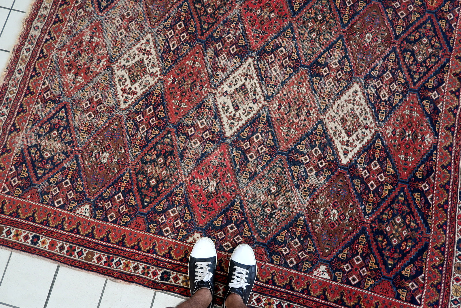 Handmade antique Persian rug from Afshar region. The rug is from the beginning of 20th century in distressed condition.