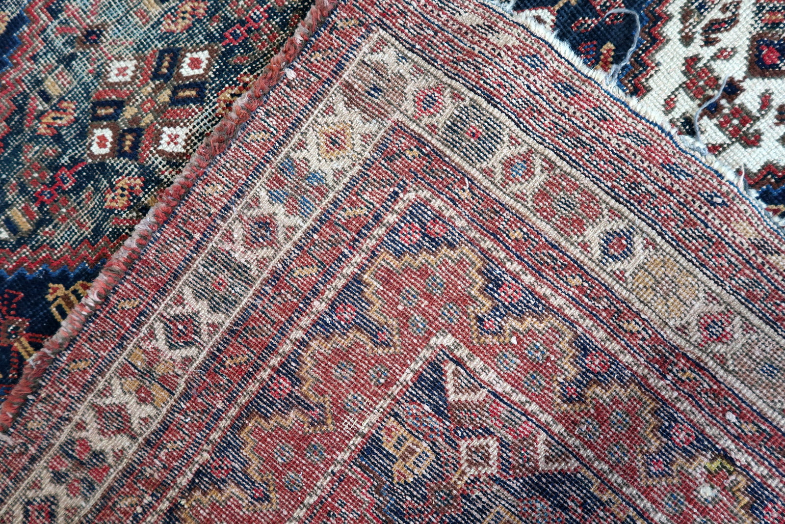 Handmade antique Persian rug from Afshar region. The rug is from the beginning of 20th century in distressed condition.
