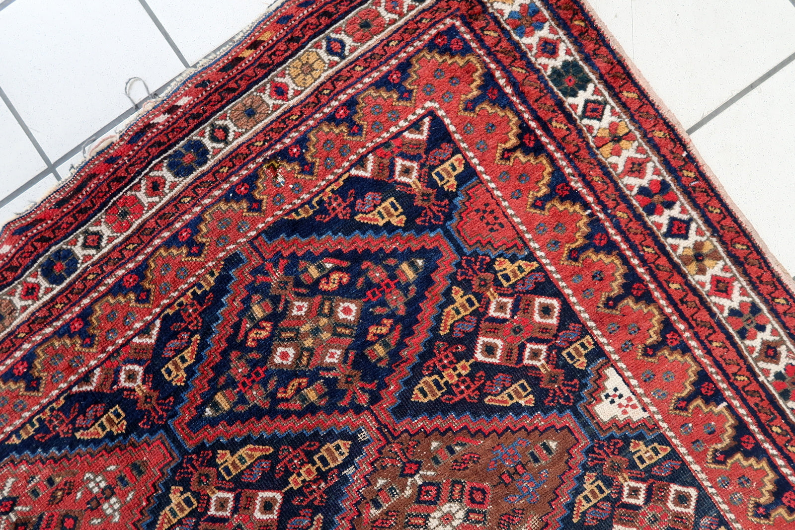 Handmade antique Persian rug from Afshar region. The rug is from the beginning of 20th century in distressed condition.