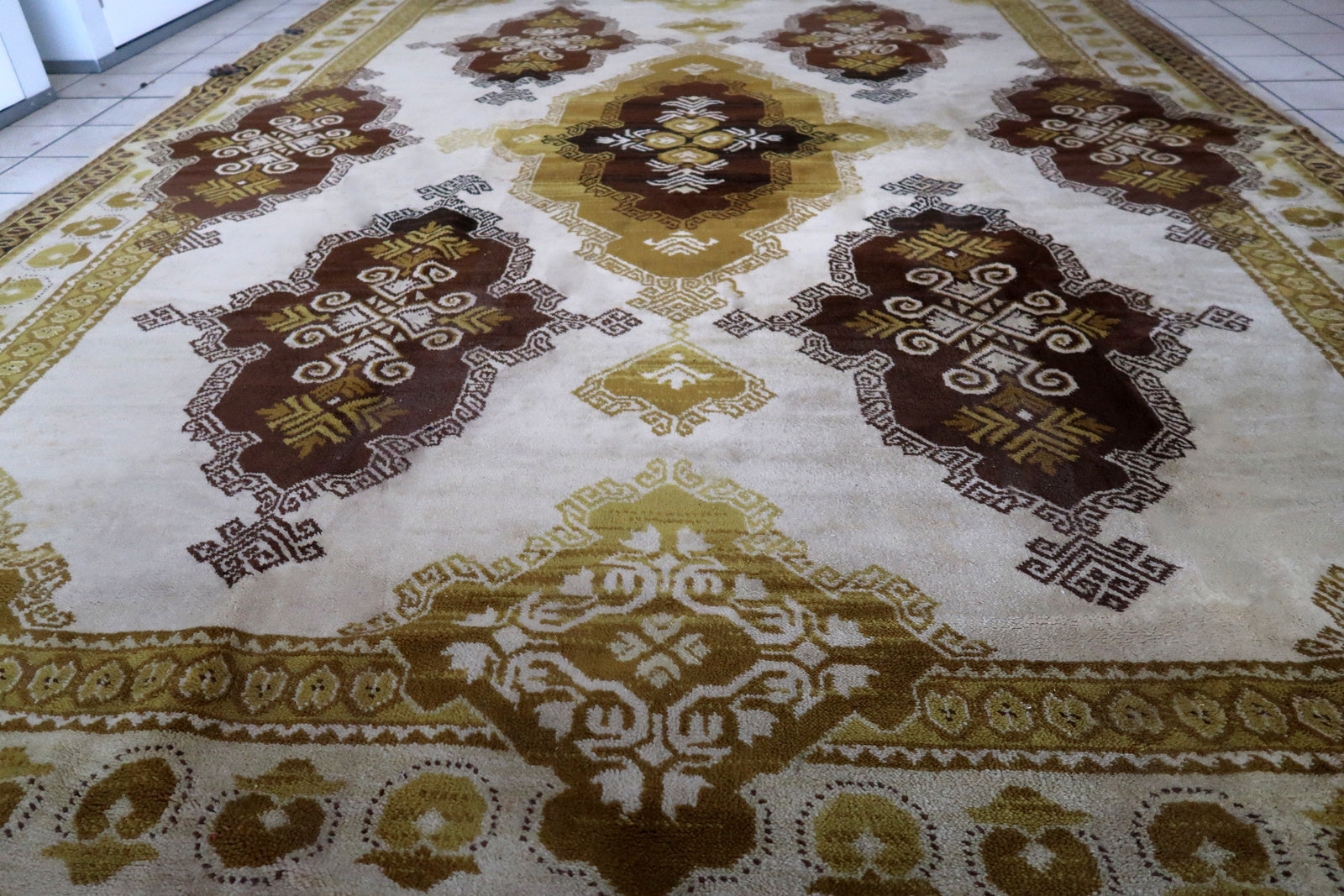 Vintage French Savonnerie rug in beige, brown and golden shades. The rug is from the middle of 20th century in original good condition.