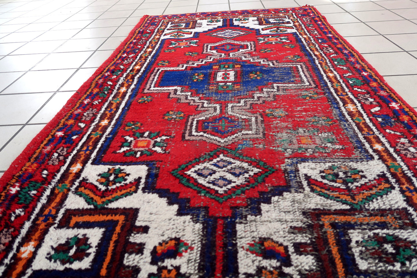 Handmade vintage Persian Hamadan rug in bright colors. The rug is from the end of 20th century in distressed condition.