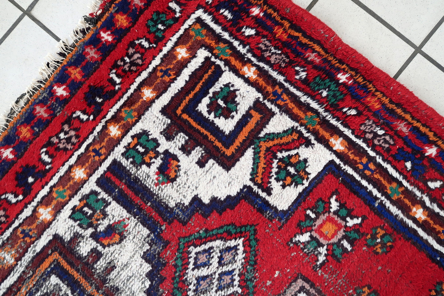 Handmade vintage Persian Hamadan rug in bright colors. The rug is from the end of 20th century in distressed condition.