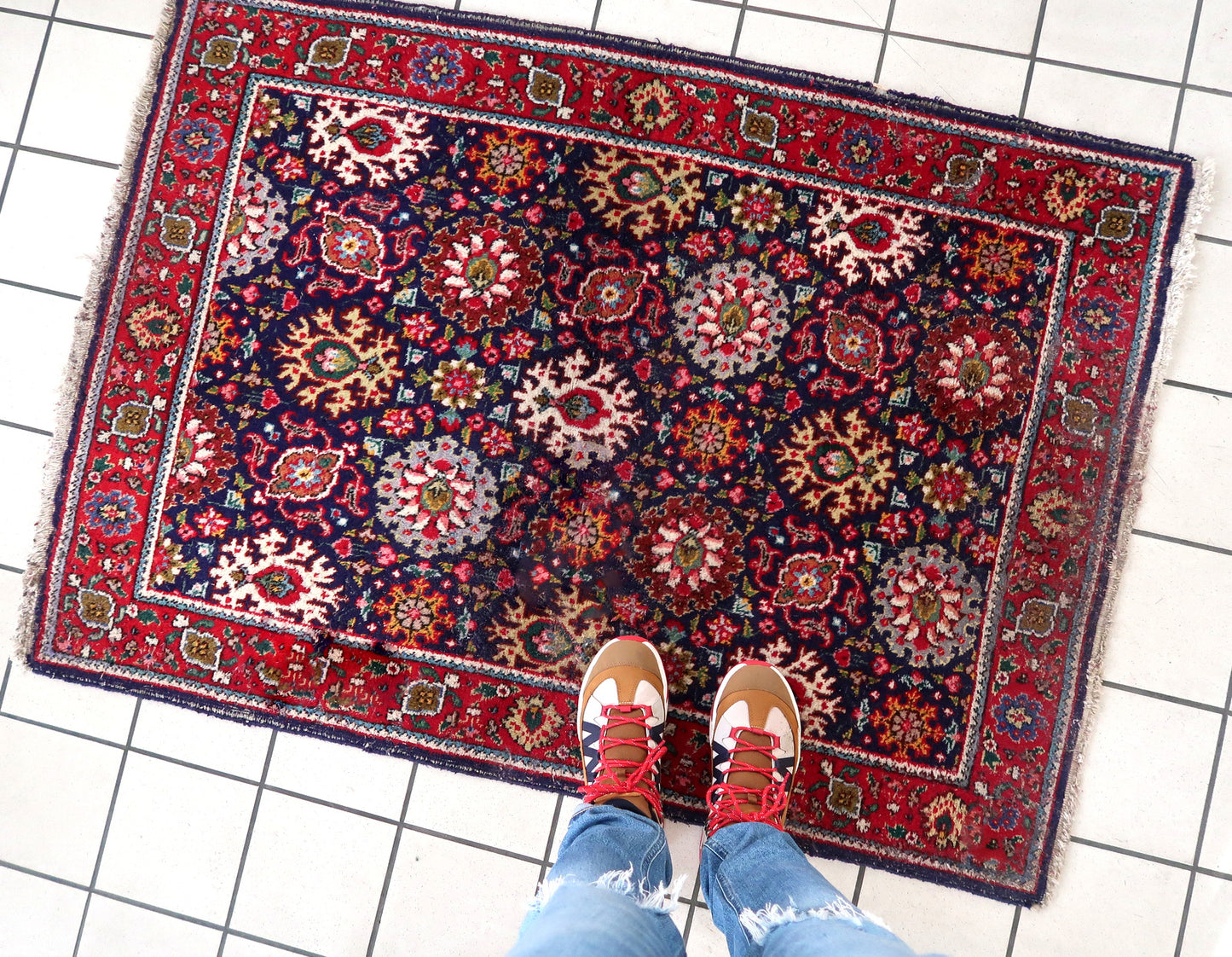 Handmade vintage Persian Tabriz rug in floral design and unusual purple background. The rug is from the middle of 20th century in good condition, it has some old restorations.