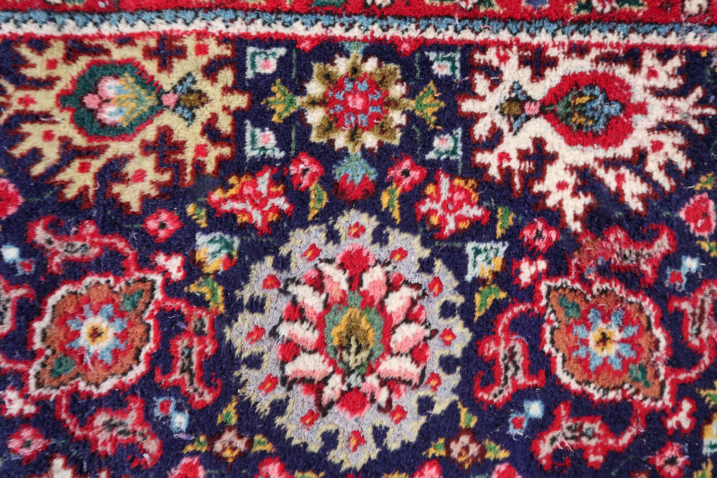 Handmade vintage Persian Tabriz rug in floral design and unusual purple background. The rug is from the middle of 20th century in good condition, it has some old restorations.