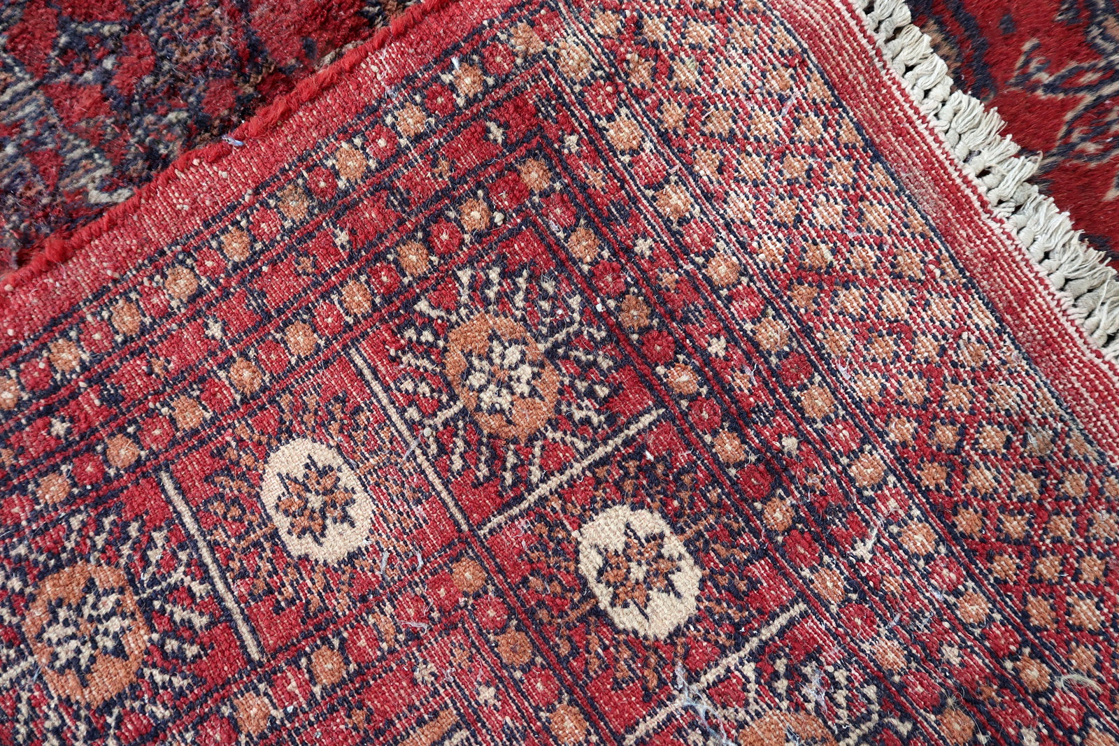 Handmade vintage Uzbek Bukhara rug in bright red color. The rug is from the end of 20th century in good condition, it has some signs of age and old restorations.