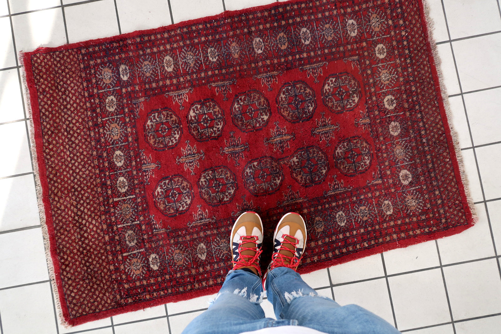 Handmade vintage Uzbek Bukhara rug in bright red color. The rug is from the end of 20th century in good condition, it has some signs of age and old restorations.