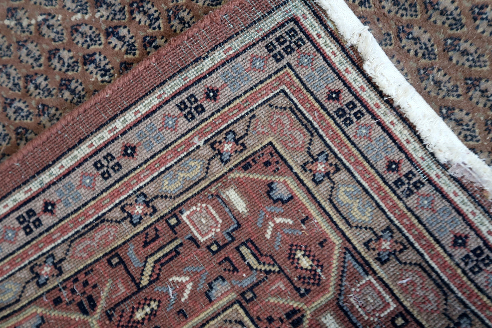 Handmade vintage Indian with Persian Seraband design in unusual brown color. The rug is from the end of 20th century in original good condition, it has minimal signs of age.