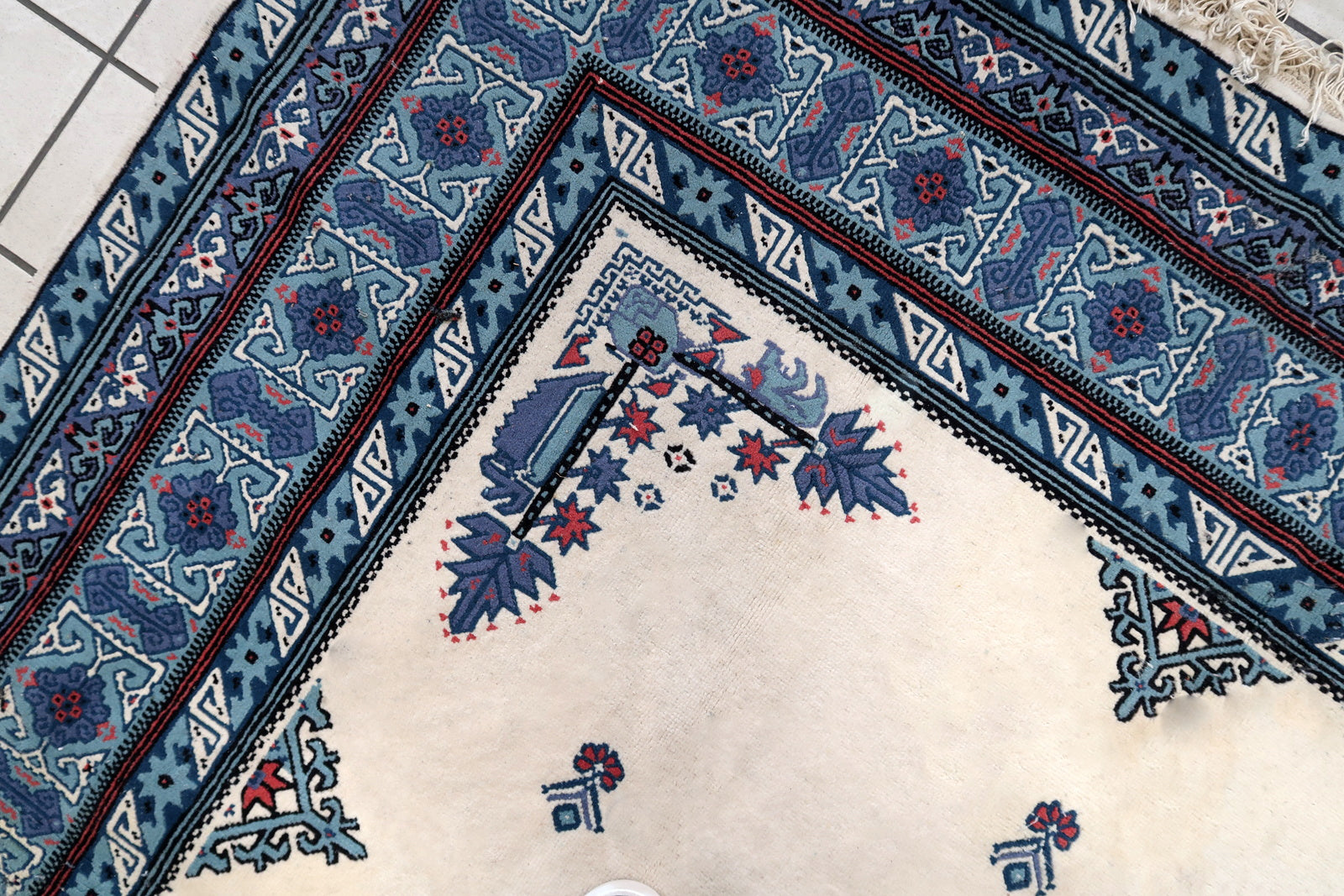 Handmade vintage Tunisian Berber rug in unusual white and blue colors. The rug is from the end of 20th century in original condition, it has some age discolorations.