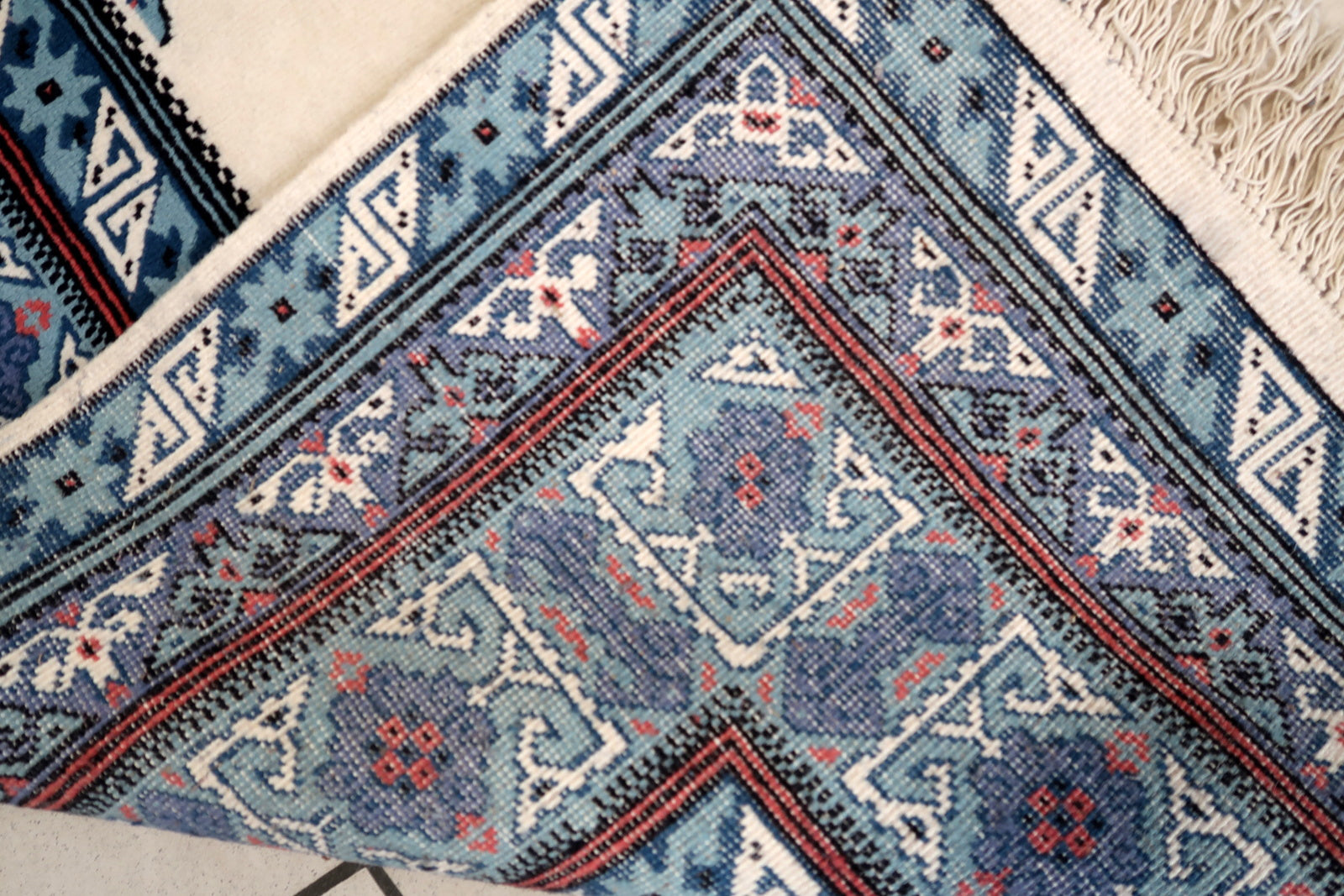 Handmade vintage Tunisian Berber rug in unusual white and blue colors. The rug is from the end of 20th century in original condition, it has some age discolorations.