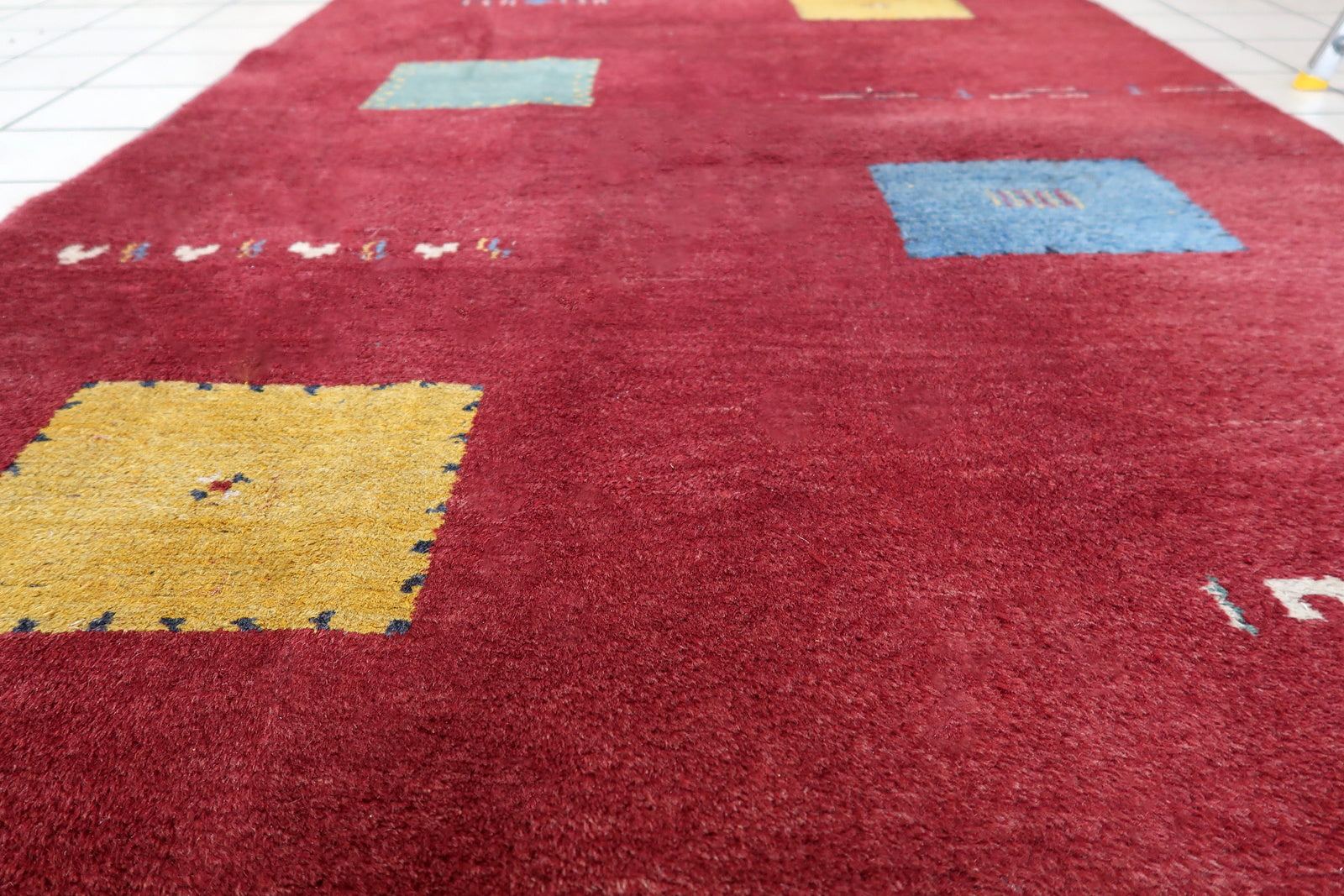 Handmade vintage Persian Gabbeh rug in deep red color and geometric design. The rug is from the end of 20th century in original good condition.