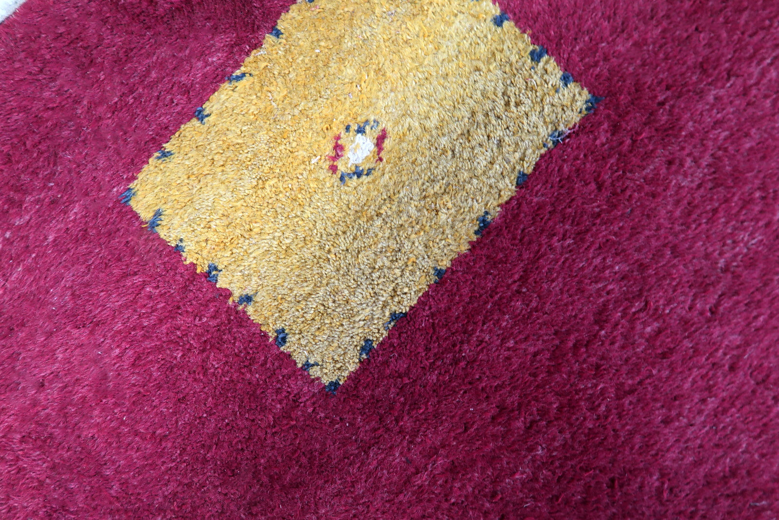 Handmade vintage Persian Gabbeh rug in deep red color and geometric design. The rug is from the end of 20th century in original good condition.