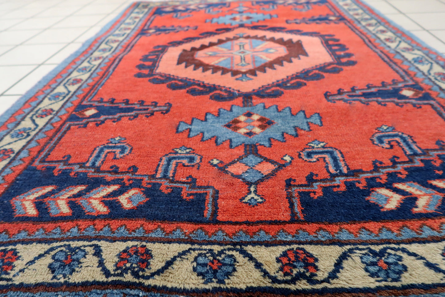 Handmade vintage rug in bright red color from Persian Hamadan region. The rug is from the end of 20th century in original good condition.