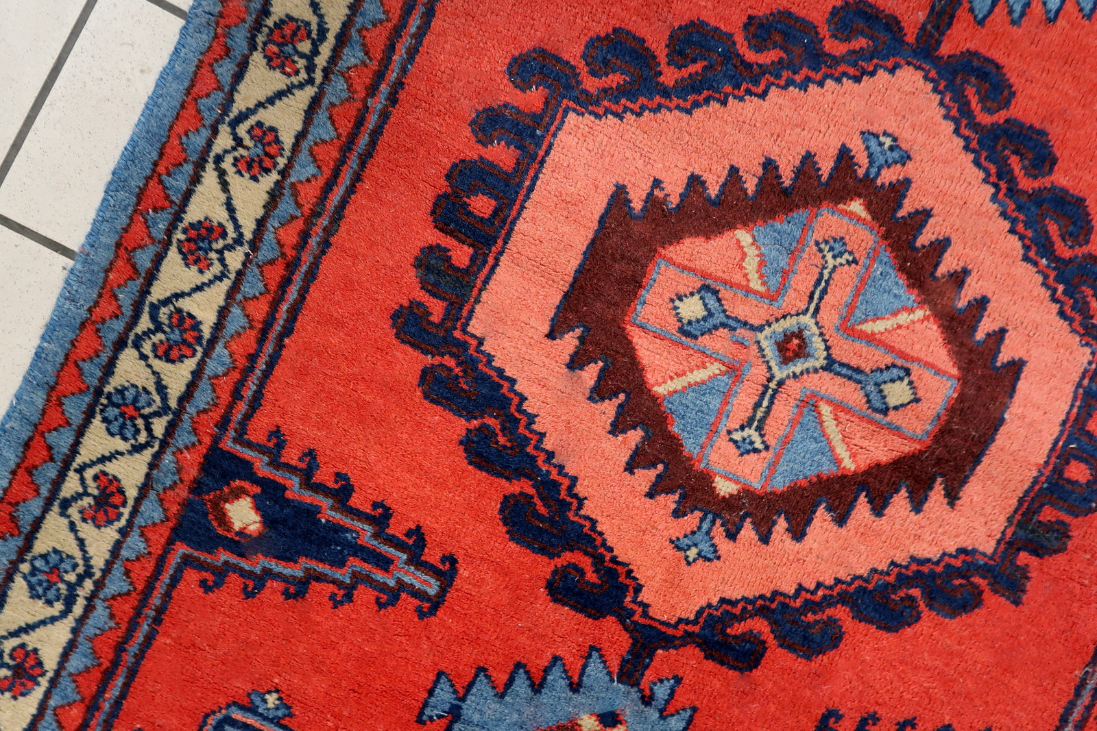 Handmade vintage rug in bright red color from Persian Hamadan region. The rug is from the end of 20th century in original good condition.