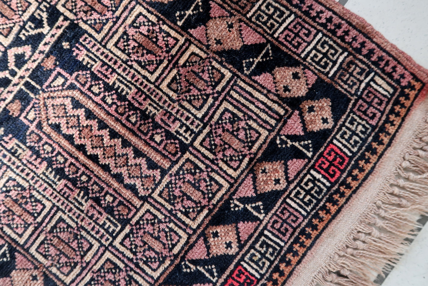 Handmade vintage Afghan Baluch rug in unusual tribal design and beautiful combination of colors. The rug is from the middle of 20th century in original good condition.