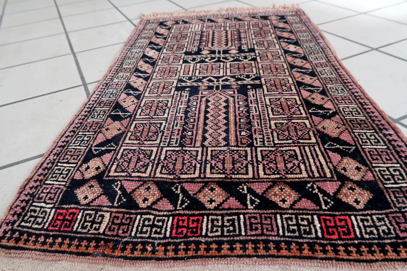 Handmade vintage Afghan Baluch rug in unusual tribal design and beautiful combination of colors. The rug is from the middle of 20th century in original good condition.