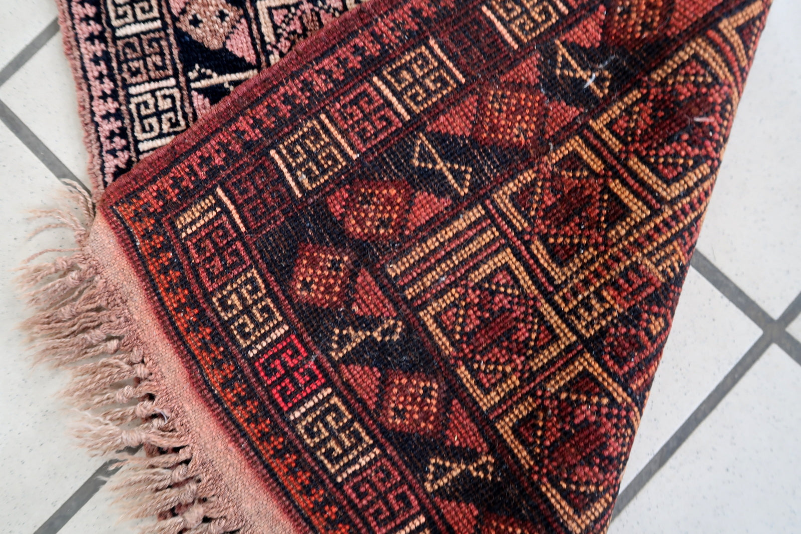 Handmade vintage Afghan Baluch rug in unusual tribal design and beautiful combination of colors. The rug is from the middle of 20th century in original good condition.