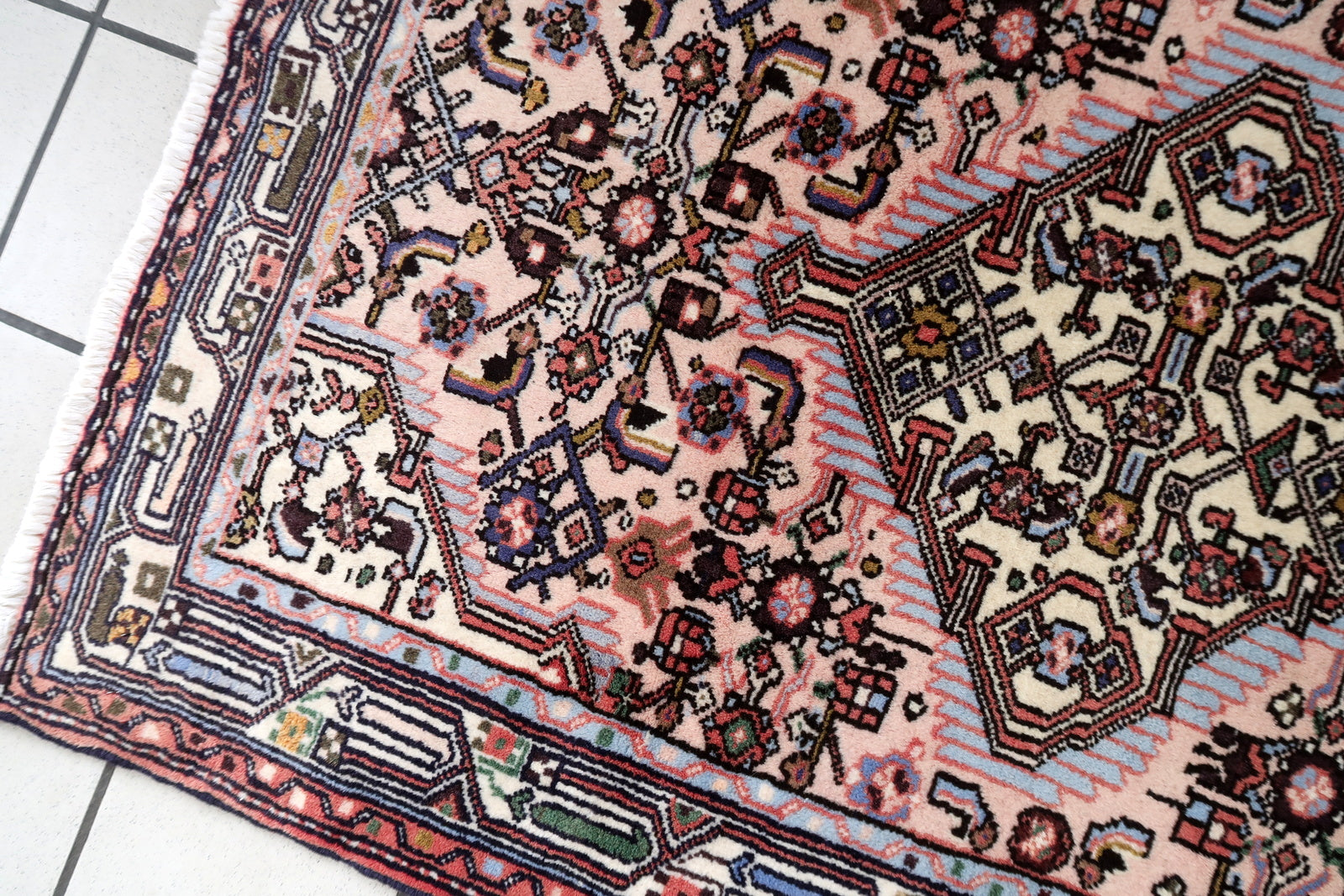 Handmade vintage Persian Malayer rug in pink color. The rug is from the middle of 20th century in original good condition.