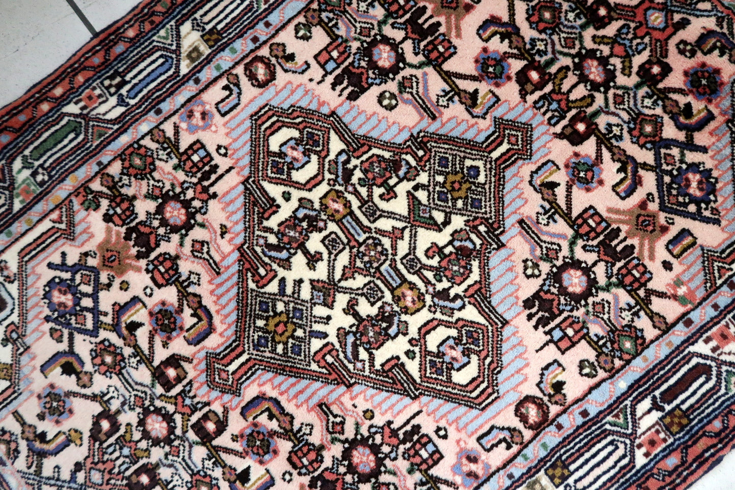 Handmade vintage Persian Malayer rug in pink color. The rug is from the middle of 20th century in original good condition.