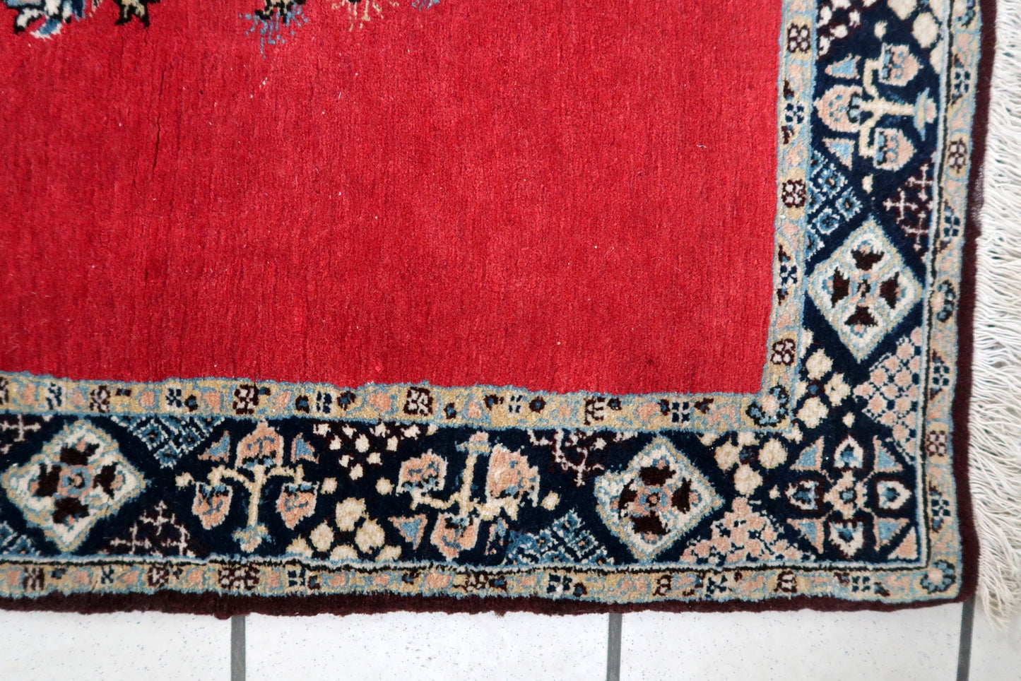 Handmade vintage Persian Tabriz rug in bright red color with large medallion. The rug is from the middle of 20th century in original good condition.