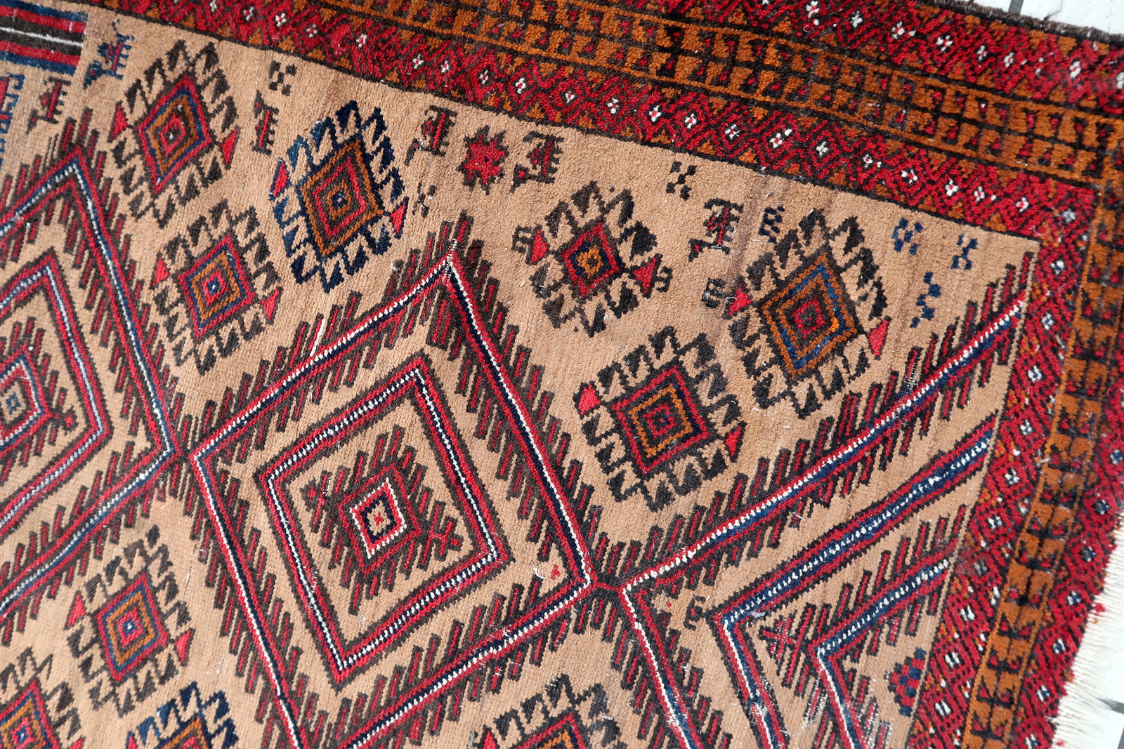 Handmade antique Afghan Baluch rug in tribal prayer design. The rug is from the beginning of 20th century in original condition, it has some low pile.