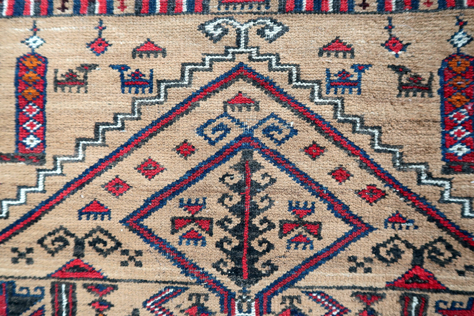 Handmade antique Afghan Baluch rug in tribal prayer design. The rug is from the beginning of 20th century in original condition, it has some low pile.