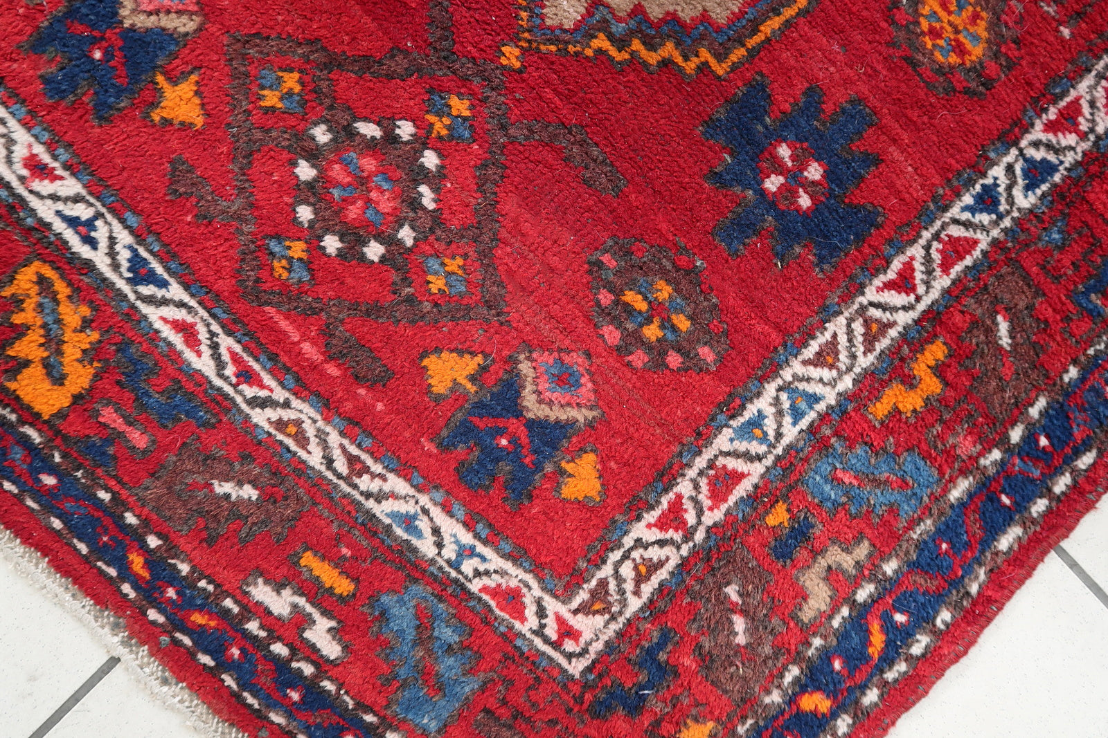 Handmade vintage Persian Hamadan rug in bright red color with large medallion. The rug is from the end of 20th century in original condition, it has some low pile.