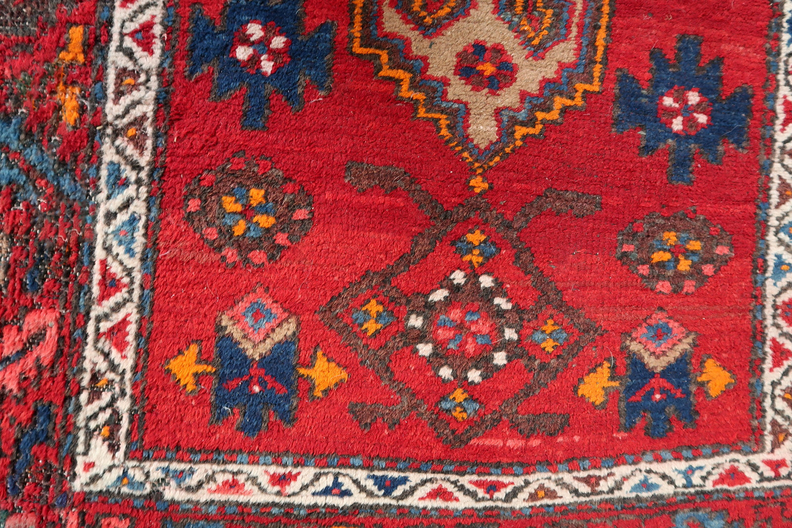 Handmade vintage Persian Hamadan rug in bright red color with large medallion. The rug is from the end of 20th century in original condition, it has some low pile.