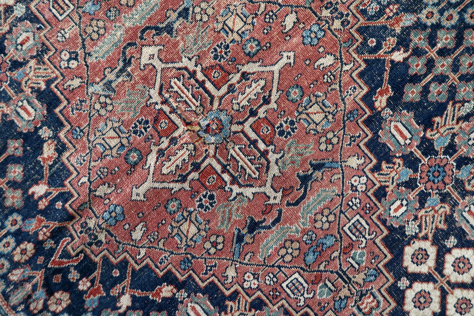 Handmade antique Persian Jozan rug in traditional design and night blue color. The rug is from the beginning of 20th century in distressed condition. On the sign it says 1335 year by Islamic calendar, it is 1915th year.
