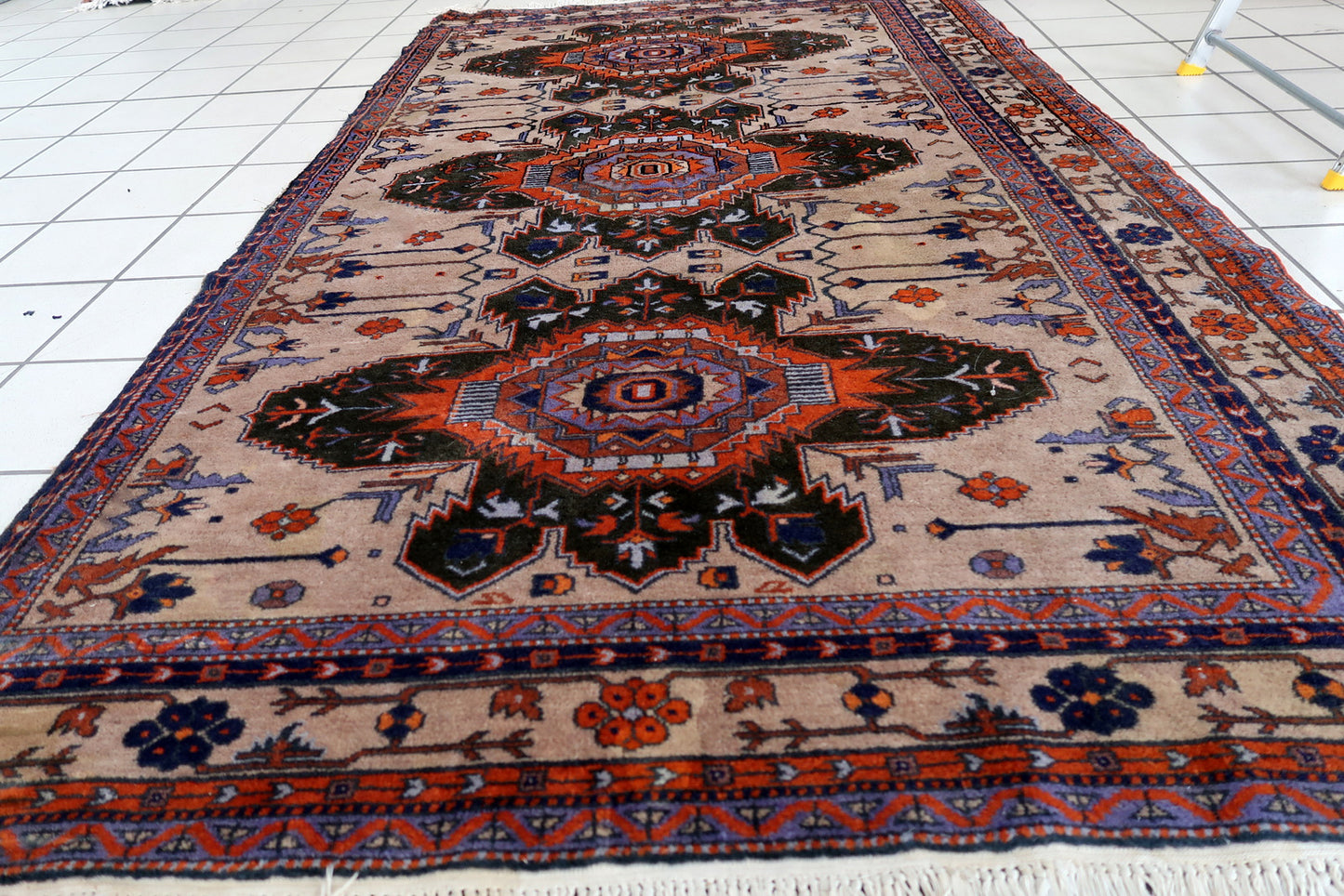 Handmade vintage Caucasian Kazak rug in traditional medallion design. The rug is from the middle of 20th century in original condition, it is missing one side.