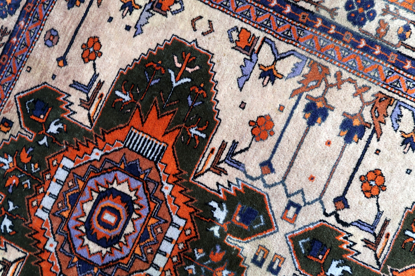 Handmade vintage Caucasian Kazak rug in traditional medallion design. The rug is from the middle of 20th century in original condition, it is missing one side.
