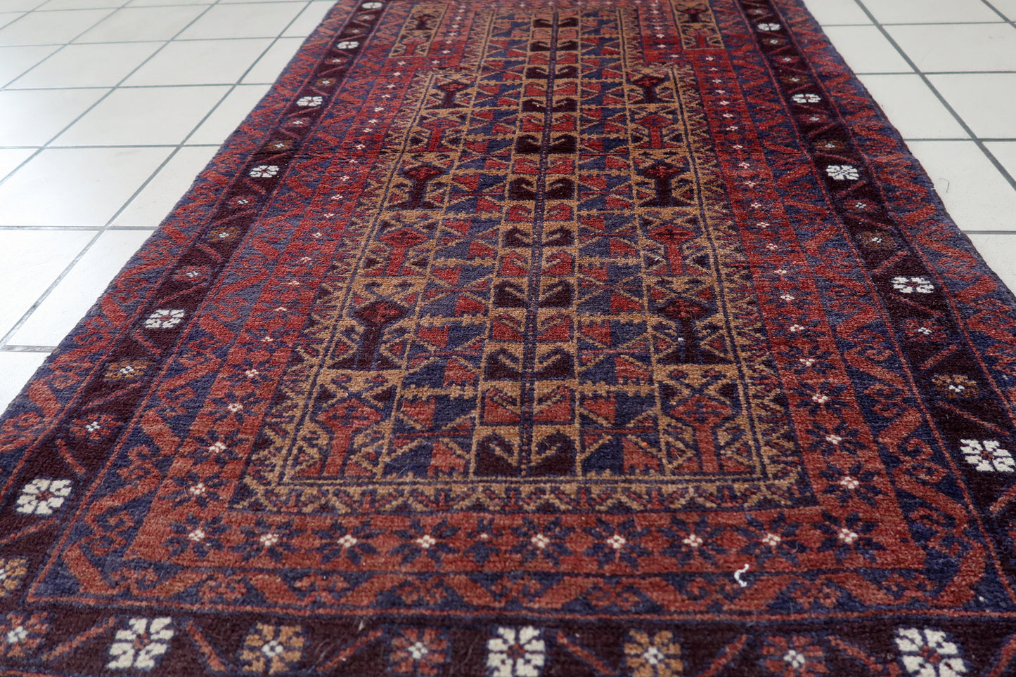 Handmade vintage Afghan Baluch rug in prayer design. The rug is from the end of 20th century in original good condition.