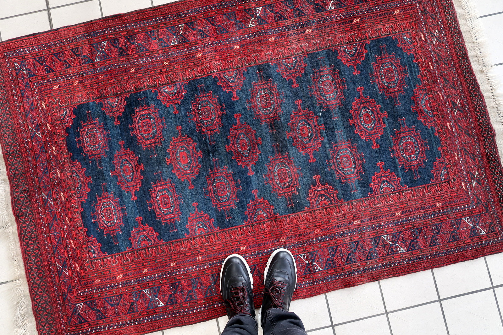 Handmade vintage Afghan Baluch rug in bright red and dark blue shades. The rug is from the middle of 20th century in original good condition.