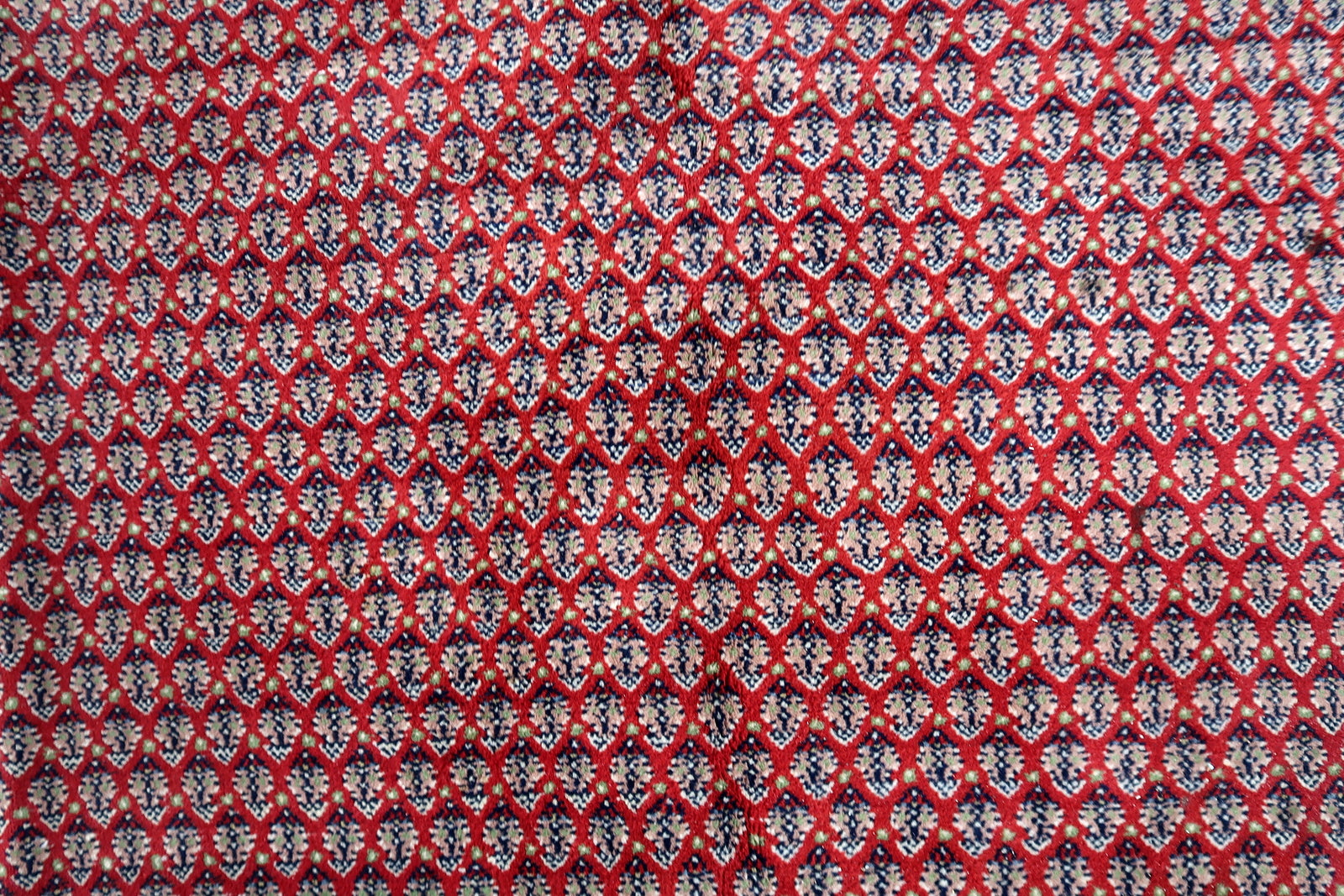 Handmade vintage Indian Seraband rug in repeating pattern and red shade. The rug is from the end of 20th century in original good condition.