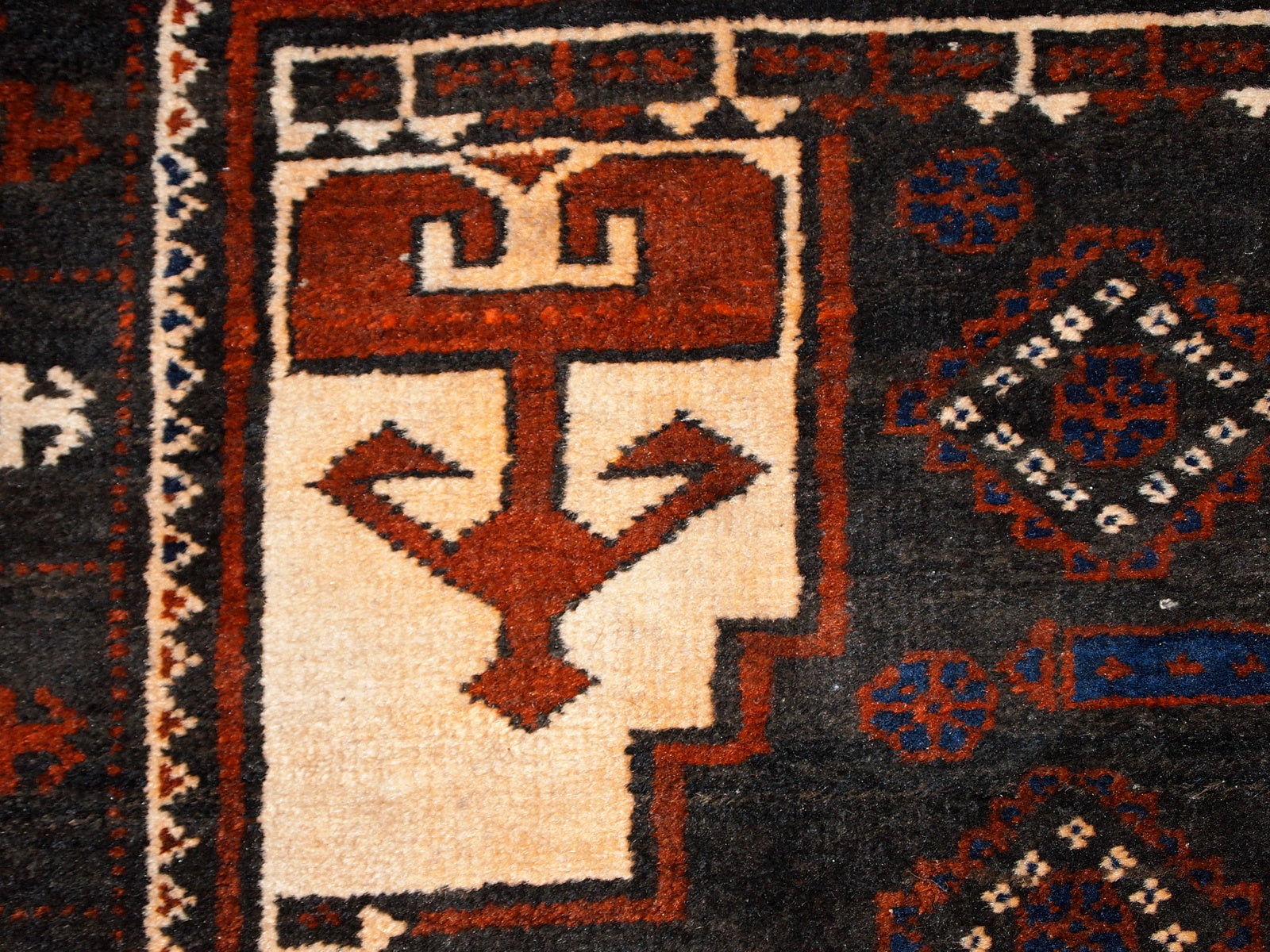 Close-up of the chocolate brown background of the Afghan rug.