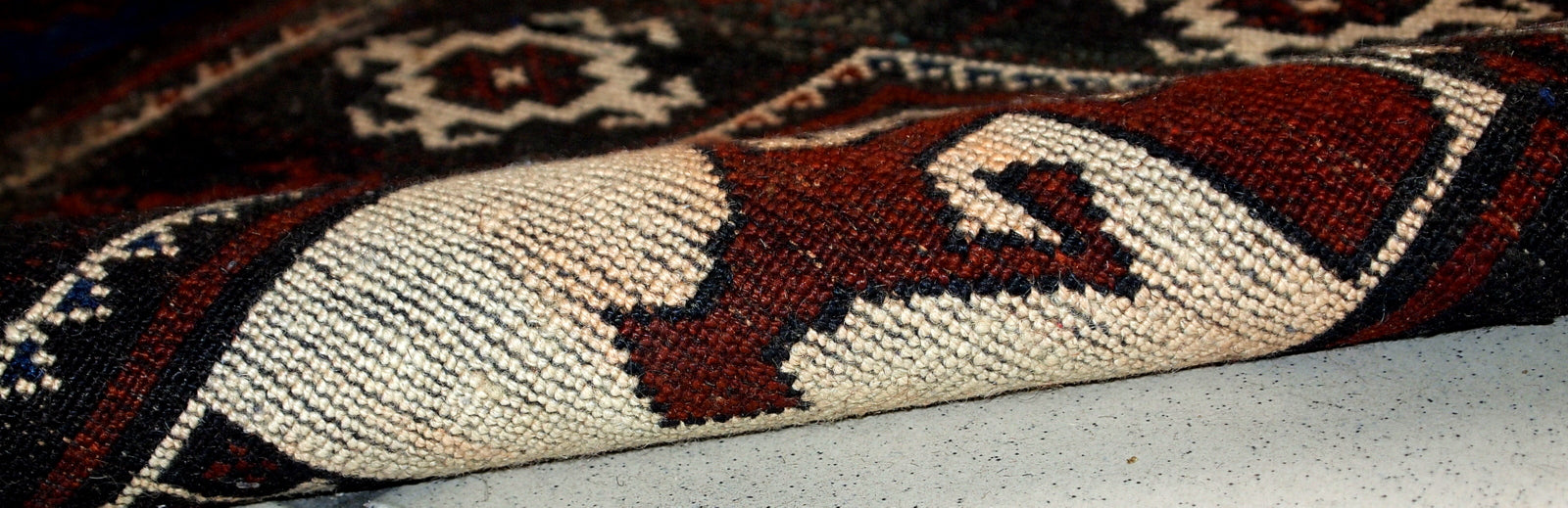 Reverse side of the vintage Afghan Baluch rug showcasing its handcrafted details and woolen texture.