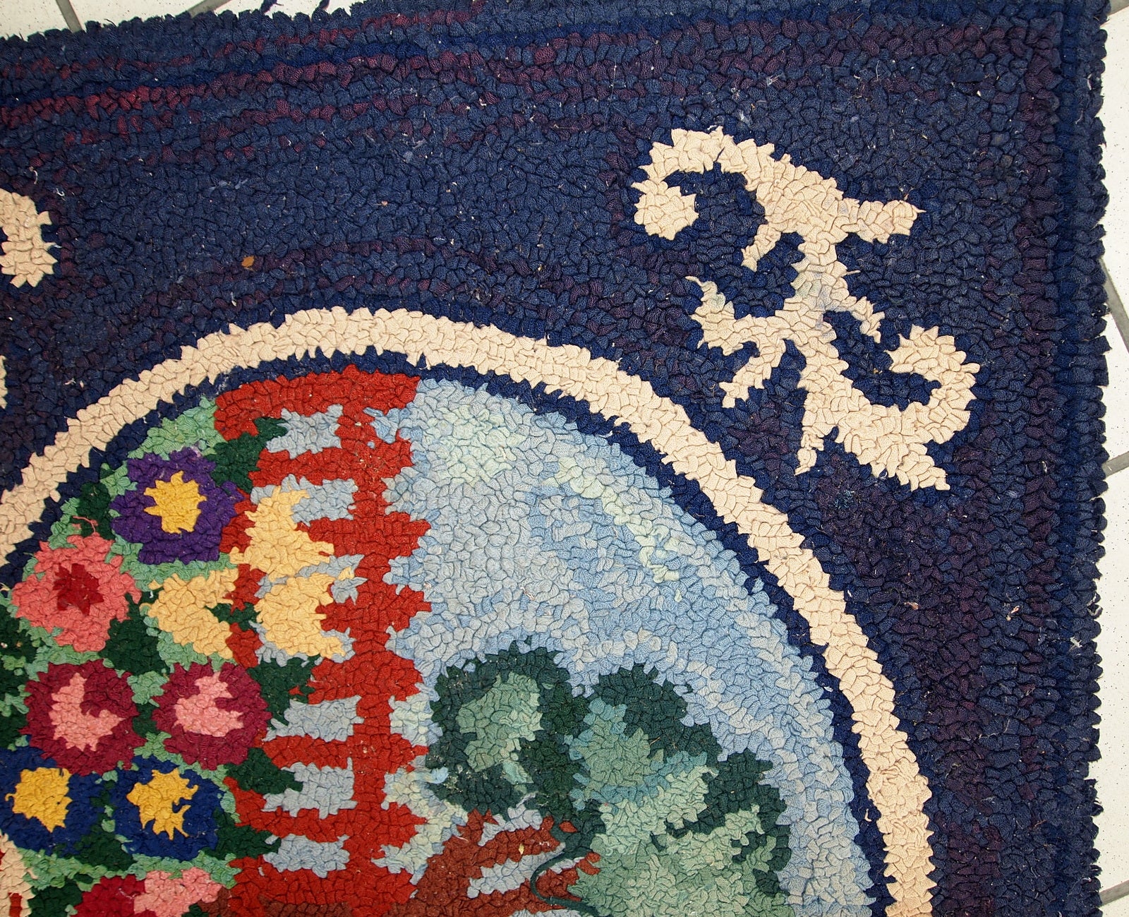 Detailed view of the rug's intricate pictorial design in vibrant shades