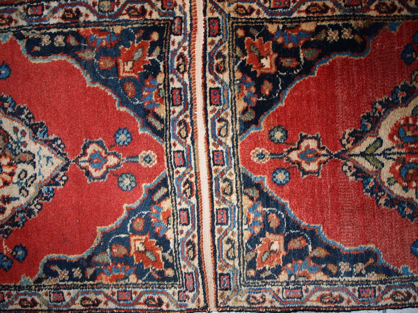 Antique Tabriz double mat in original good condition, one of the rugs has some low pile. The design is traditional with decorative birds in the center. 