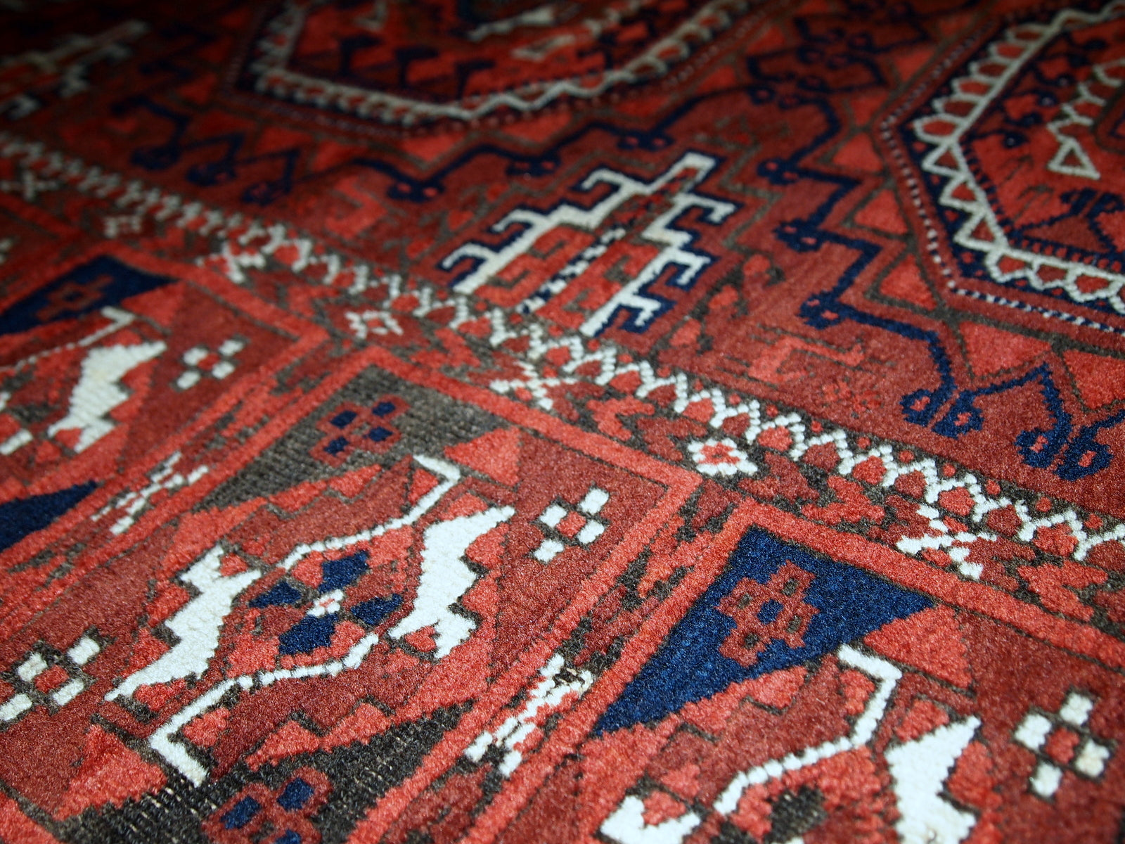 Antique hand made Afghan Baluch rug in original condition, has some age wear. The rug is in traditional deep burgundy shade with navy blue and white accents, has very rich combination of colors. 