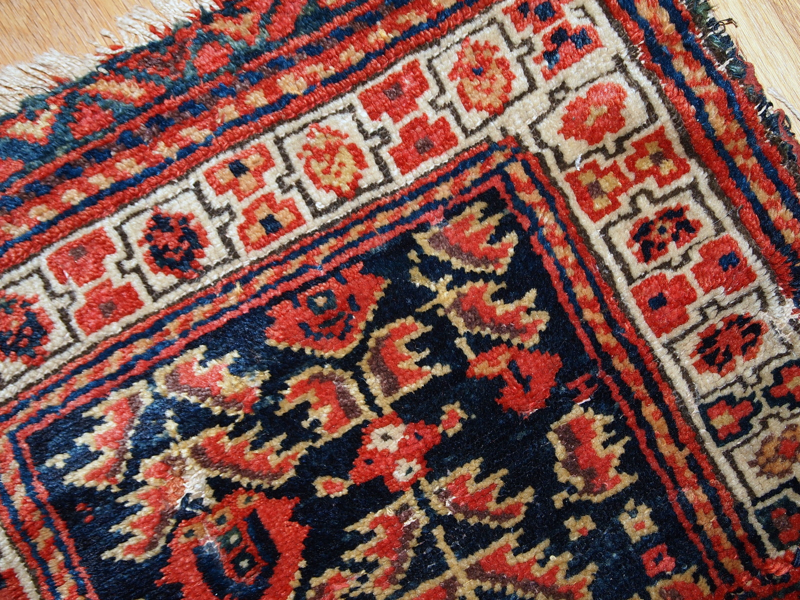 Hand made antique Malayer bag face in original condition with some age wear. The rug made has traditional tribal design in navy blue, white and red shades. 
