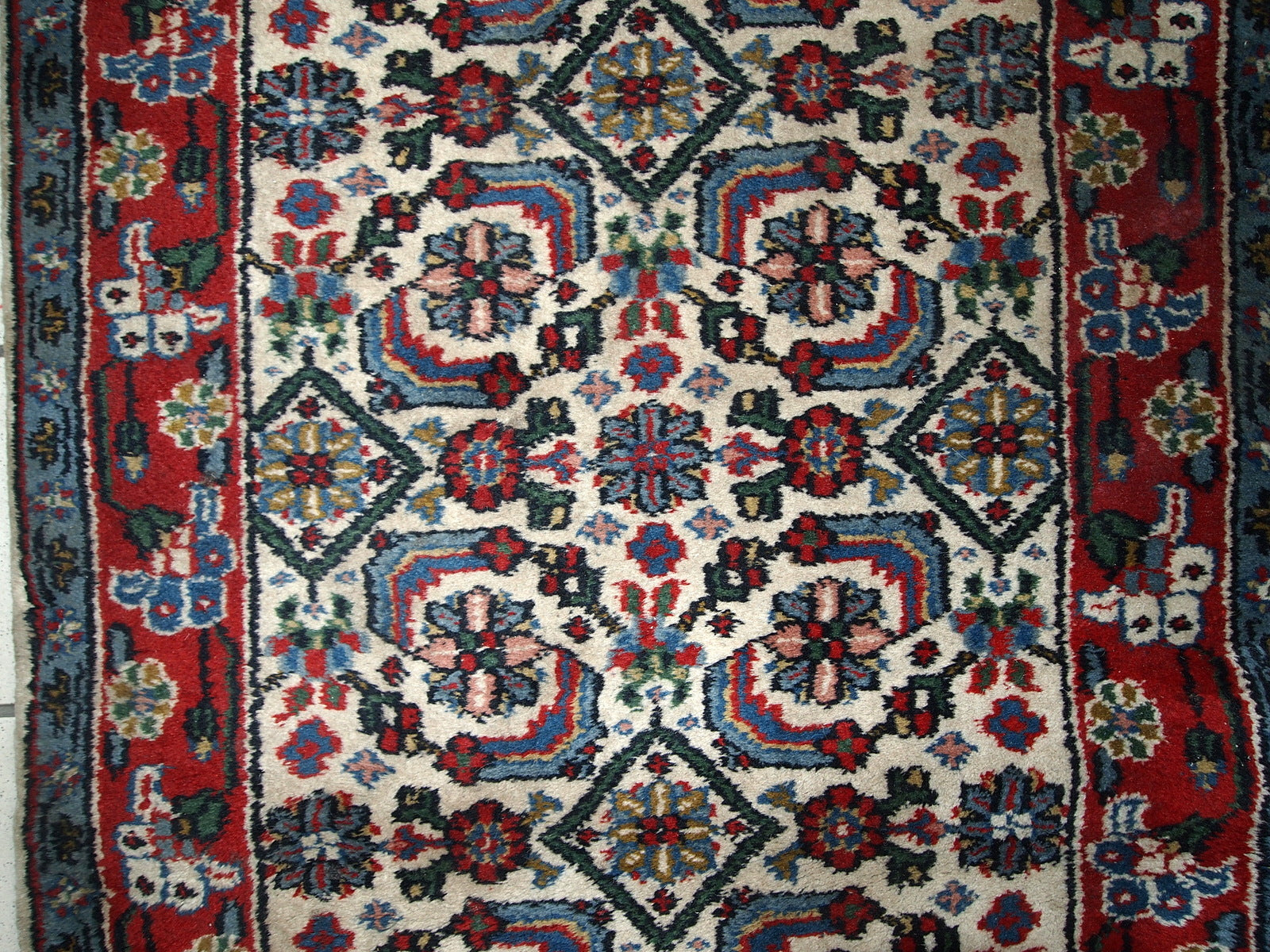 Vintage Indian Agra rug in original good condition. The rug made in white, blue and red shades.
