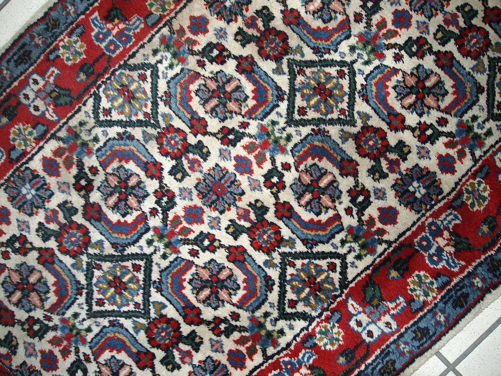Vintage Indian Agra rug in original good condition. The rug made in white, blue and red shades.
