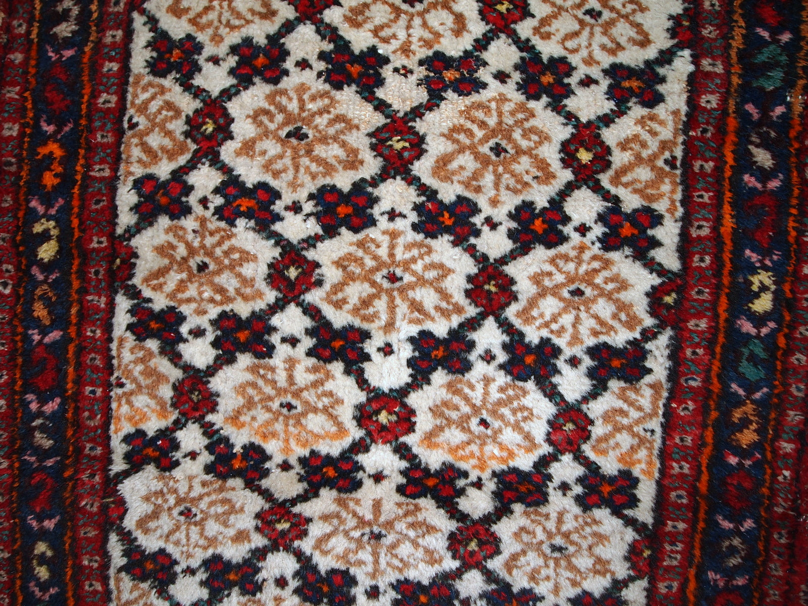 Antique Hamadan runner in good original condition. The rug is in white, red and blue shades.