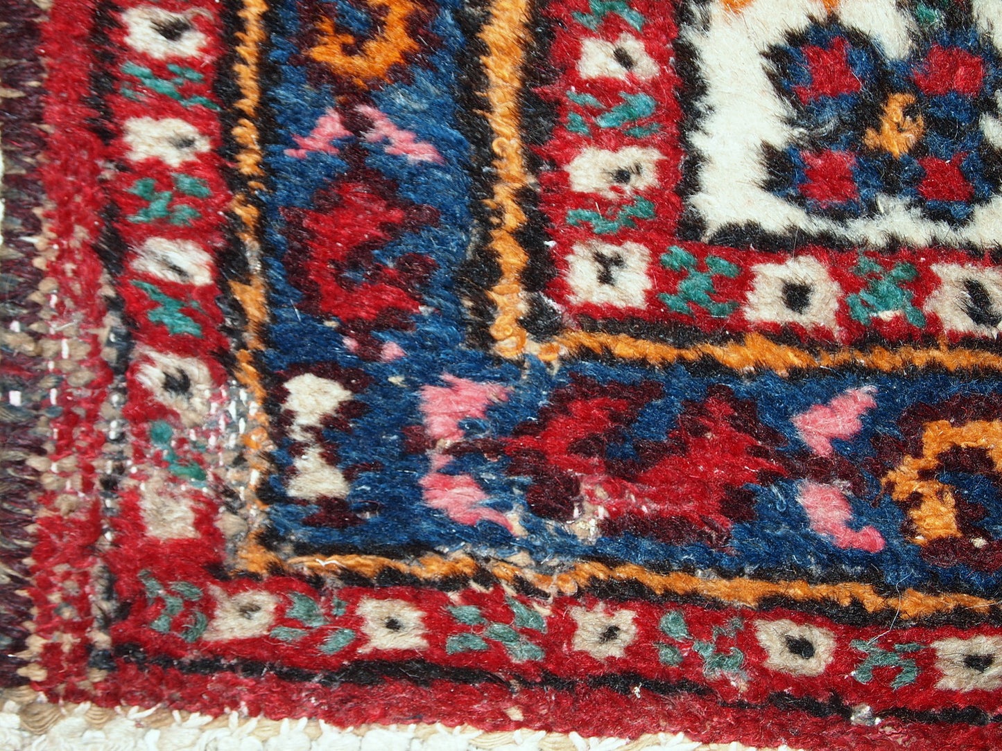 Antique Hamadan runner in good original condition. The rug is in white, red and blue shades.