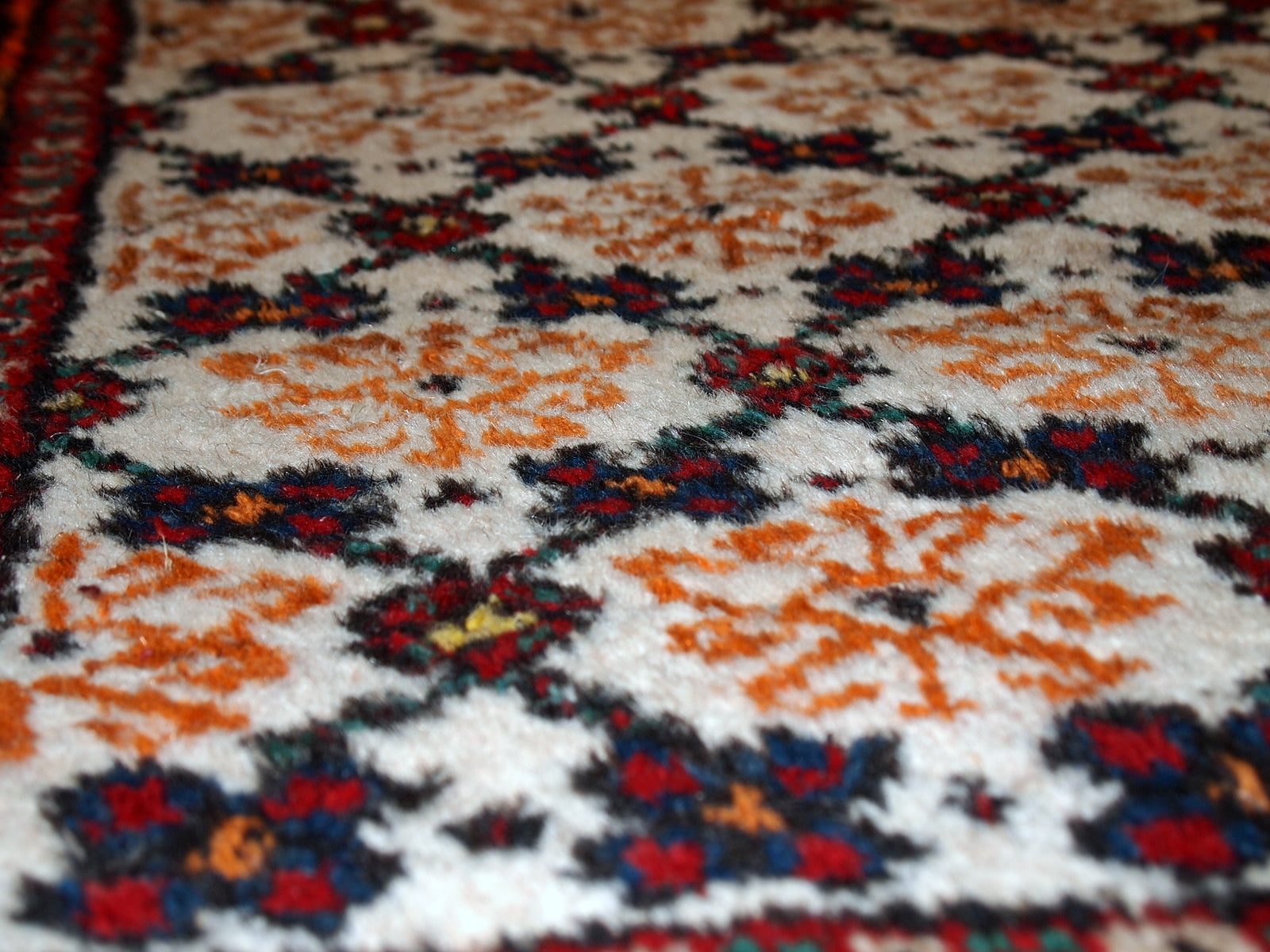 Antique Hamadan runner in good original condition. The rug is in white, red and blue shades.