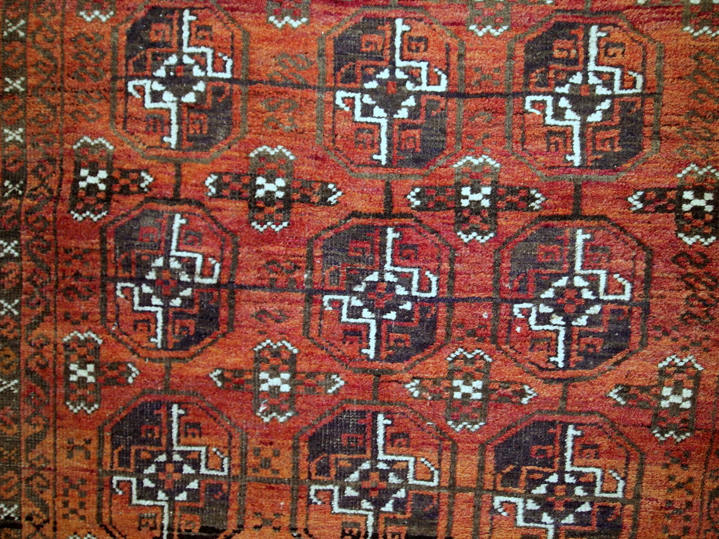 Antique hand made Afghan Baluch rug in original good condition. This rug is in brick red shade with repeating design.