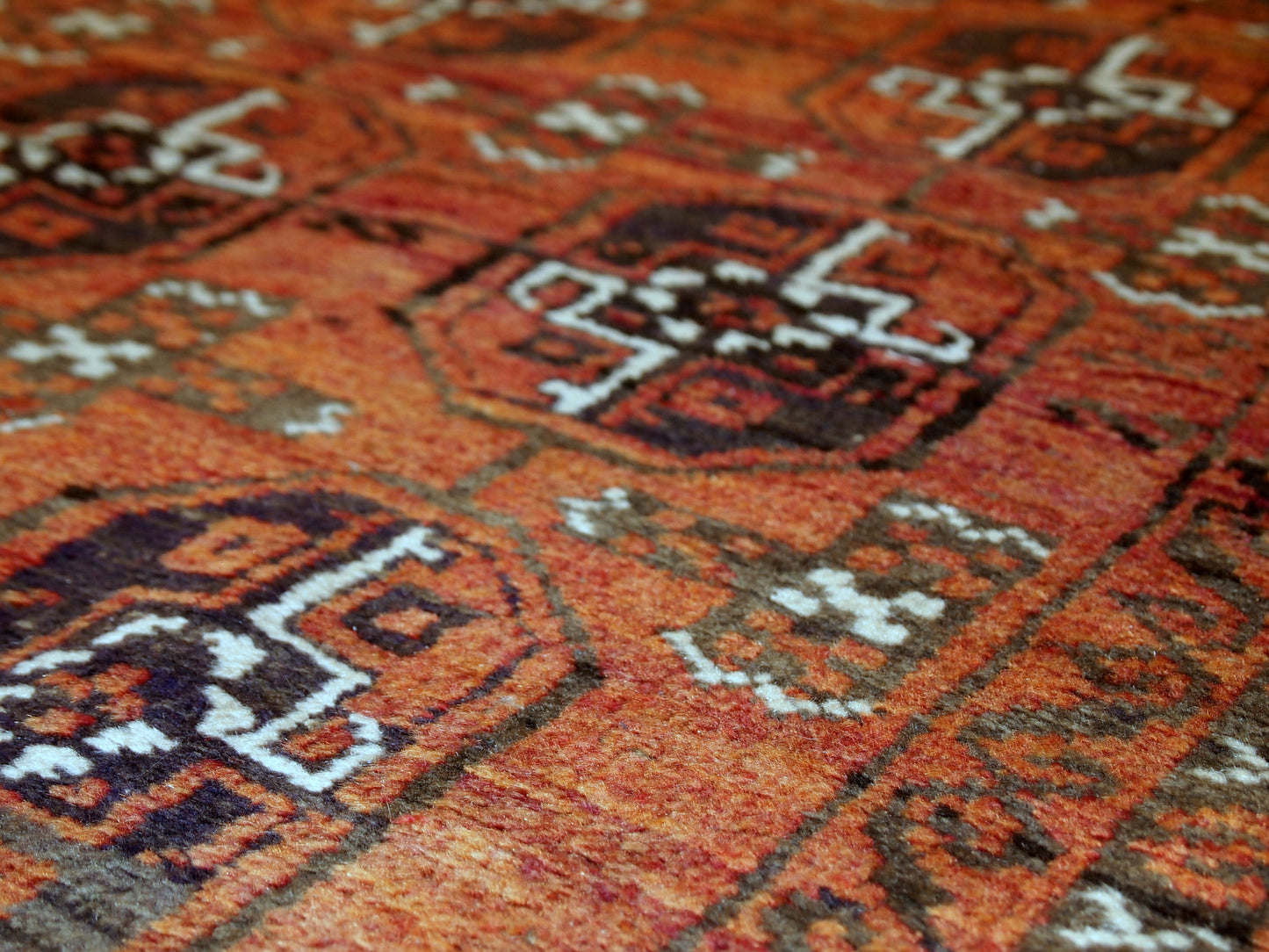 Antique hand made Afghan Baluch rug in original good condition. This rug is in brick red shade with repeating design.