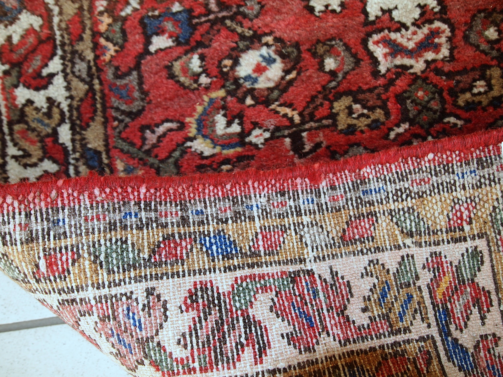 Vintage Persian Hamadan rug in good original condition. The rug is from the middle of 20th century made in red wool.
